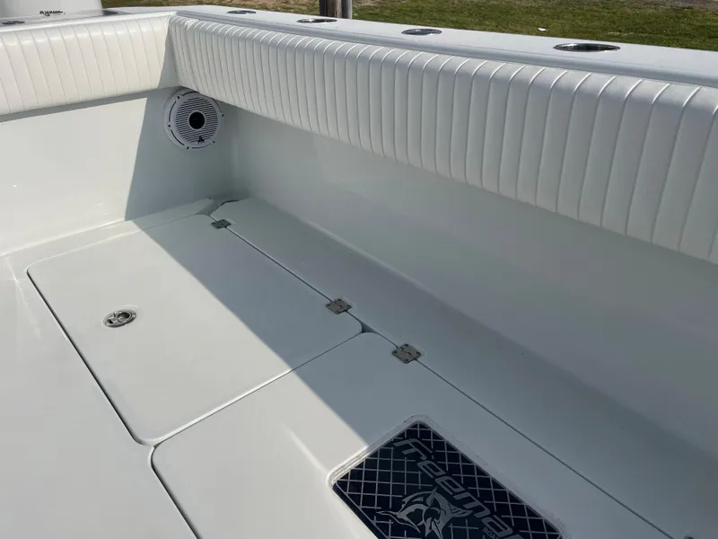 Slide: The Image of 2019 Freeman 37 boat interior with white cushioned seating and storage compartments. - 45