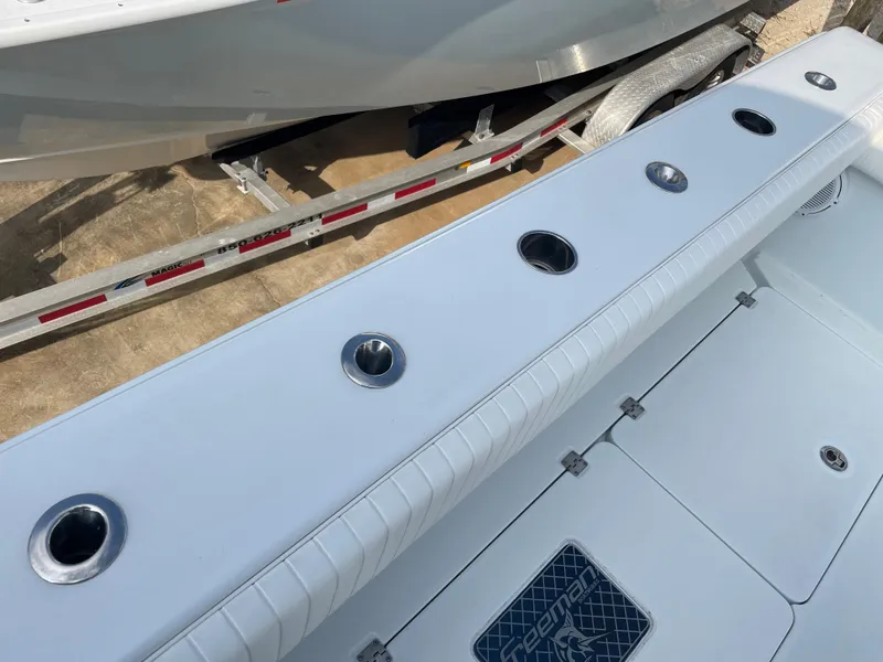 Slide: The Image of 2019 Freeman 37 boat deck with rod holders and storage compartments. - 49