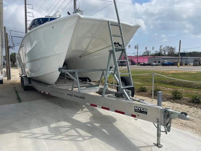 Slide: The Image of Freeman 37 boat on Myco trailer, 2019 model, parked outdoors. - 6