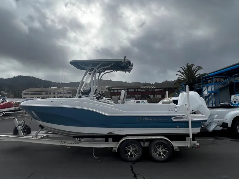 Slide: The Image of 2023 Finseeker 230 CC boat on a trailer in a marina. - 13