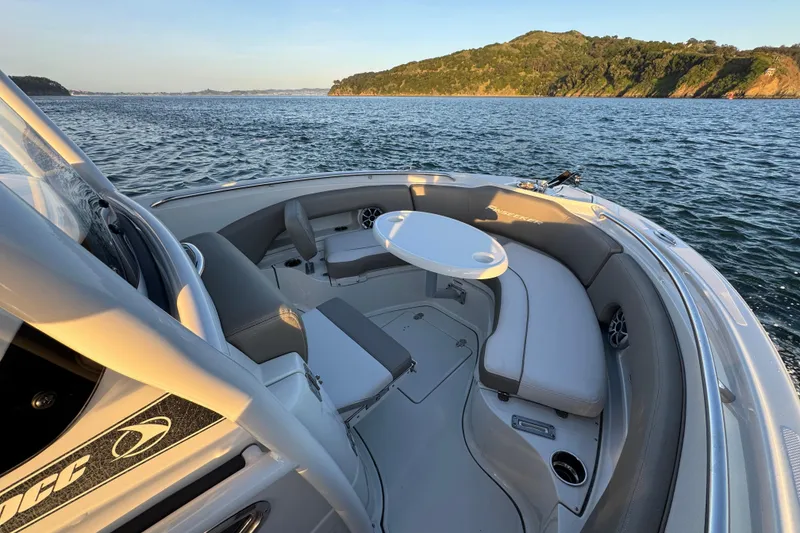 Slide: The Image of 2023 Finseeker 230 CC boat interior with seating and table on open water. - 24