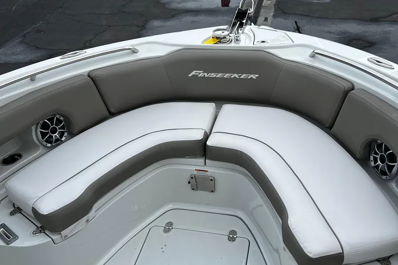 Slide: The Image of 2023 Finseeker 230 CC boat with cushioned seating and built-in speakers. - 7