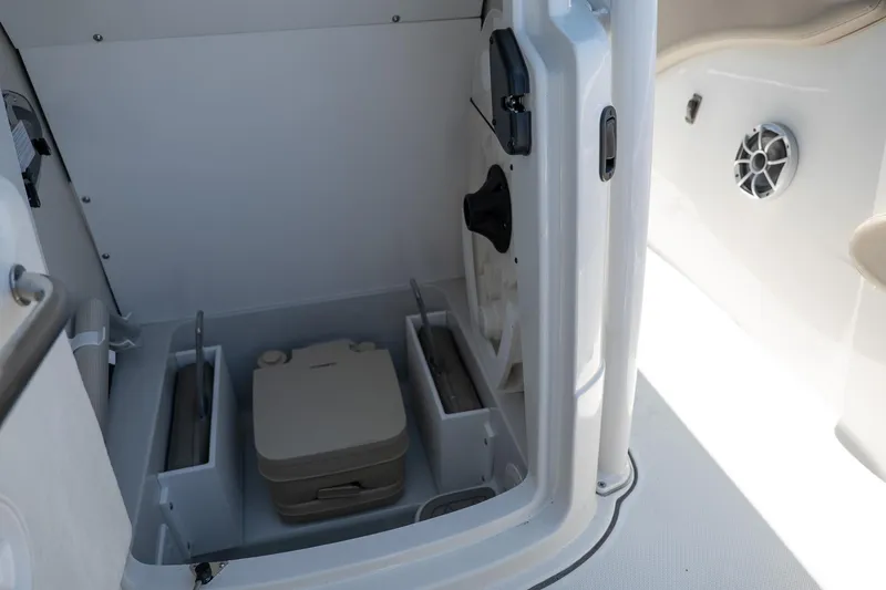 Slide: The Image of 2023 Finseeker 230 CC boat interior storage compartment with portable toilet. - 8