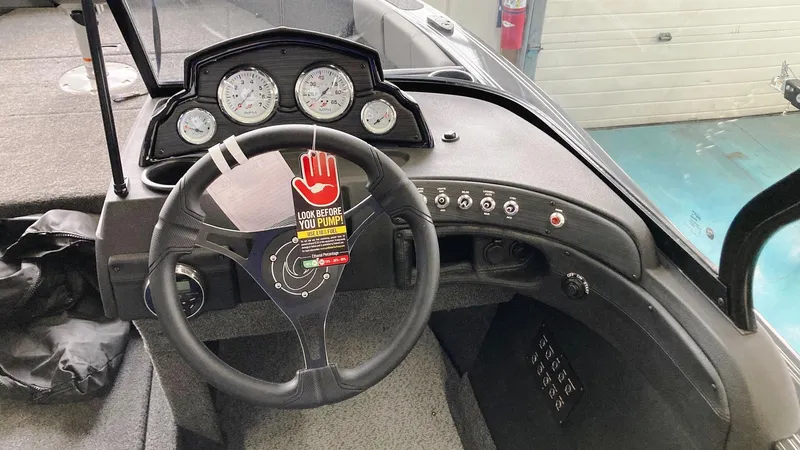Slide: The Image of 2023 Crestliner 1850 Super Hawk dashboard with steering wheel and gauges. - 4