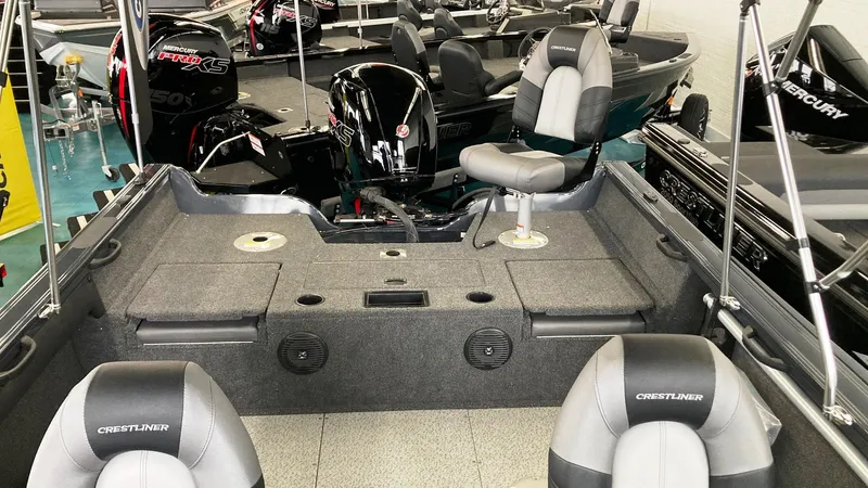 Slide: The Image of 2023 Crestliner 1850 Super Hawk boat interior with seating and motor. - 5