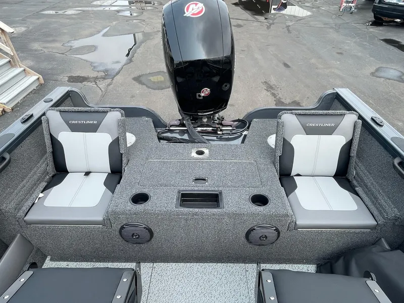 Slide: The Image of 2023 Crestliner 1850 Super Hawk boat interior with seating and motor. - 6