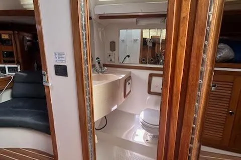 Slide: The Image of Interior of 2000 Catalina 42 Mk II yacht featuring bathroom and wooden cabinetry. - 10