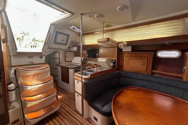 Slide: The Image of Interior of 2000 Catalina 42 Mk II sailboat with wood finishes and cozy seating area. - 15