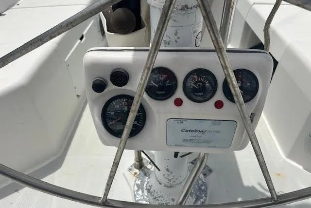 Slide: The Image of Control panel of a 2000 Catalina 42 Mk II sailboat, featuring gauges and dials. - 3