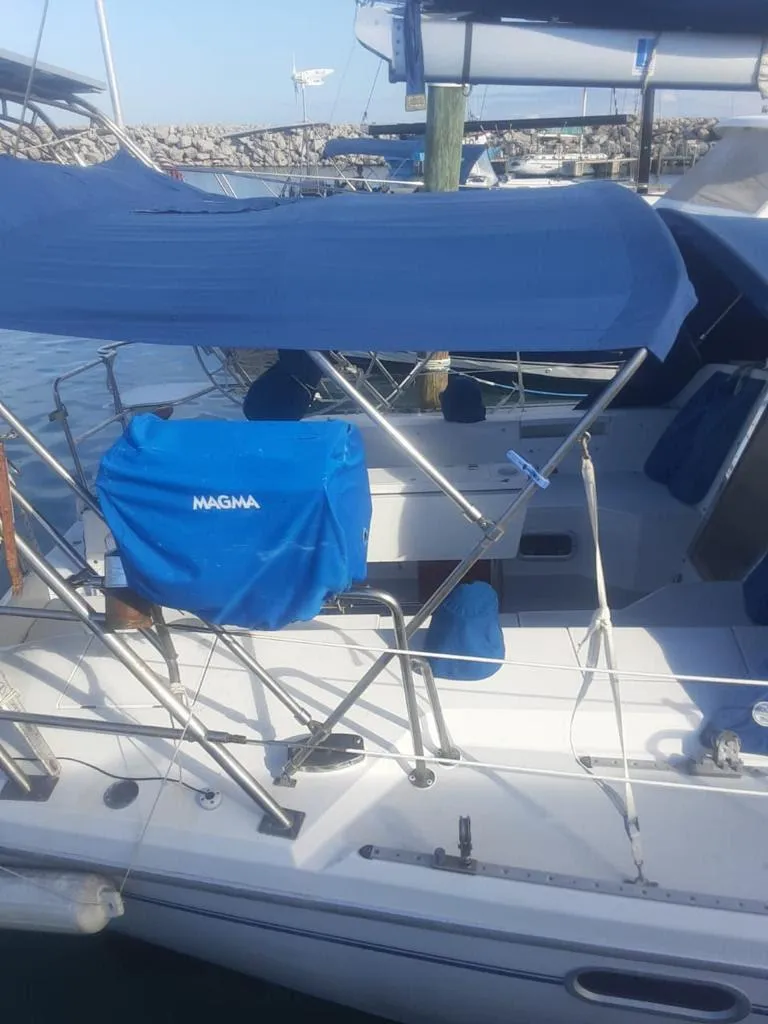 Slide: The Image of Catalina 42 Mk II 2000 sailboat docked at marina with blue canopy and Magma grill. - 7