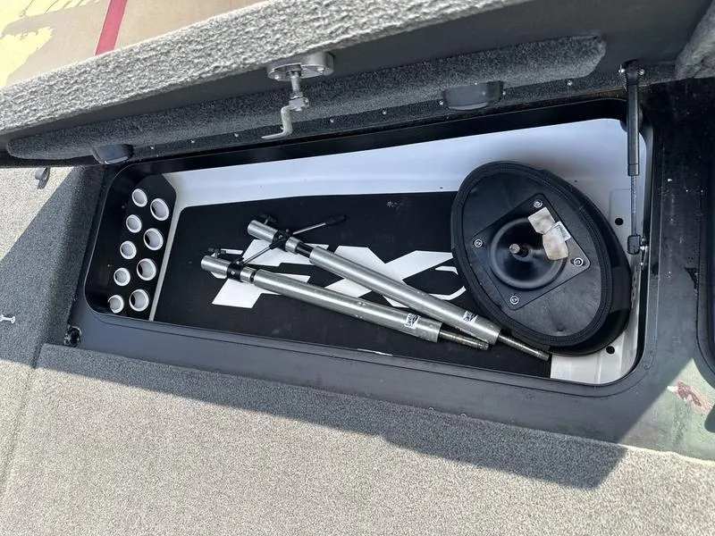 Slide: The Image of 2019 Skeeter FX21 LE storage compartment with fishing rod holders and accessories. - 2