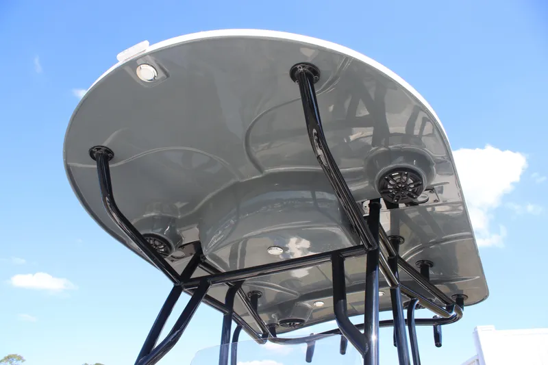 Slide: The Image of 2025 Carolina Skiff 21 Ultra Elite T-top with speakers against blue sky. - 10