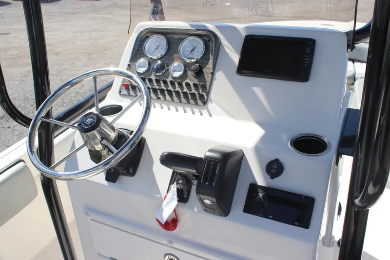 Slide: The Image of 2025 Carolina Skiff 21 Ultra Elite boat console with steering wheel and gauges. - 11