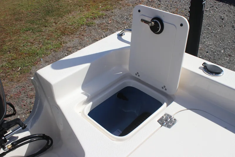 Slide: The Image of 2025 Carolina Skiff 21 Ultra Elite boat storage compartment with open hatch. - 12