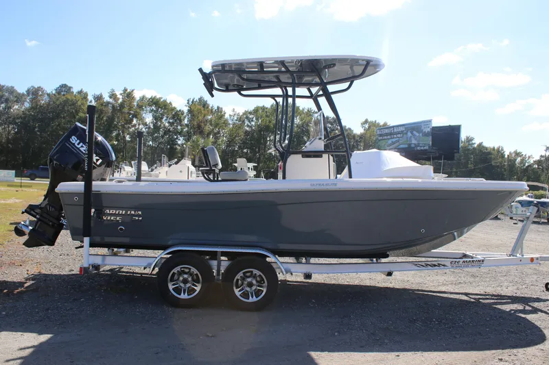Slide: The Image of 2025 Carolina Skiff 21 Ultra Elite boat on trailer, side view, outdoors. - 2