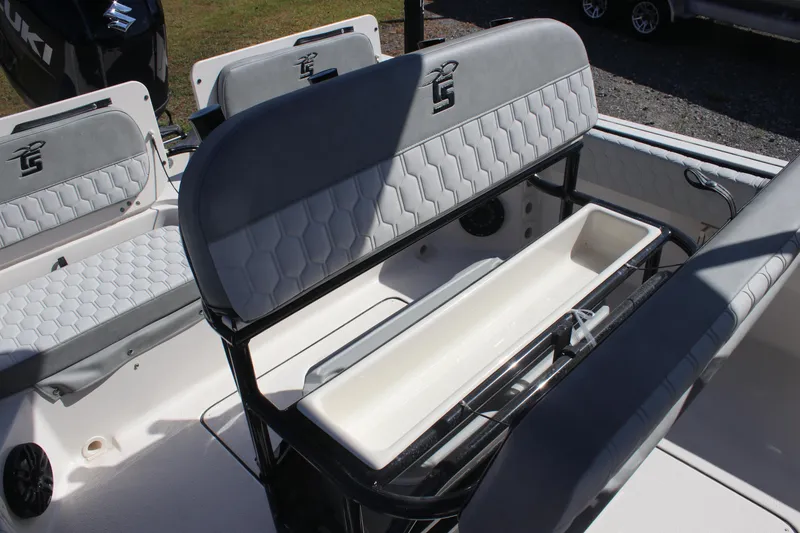 Slide: The Image of 2025 Carolina Skiff 21 Ultra Elite boat interior with cushioned seating and storage compartment. - 5