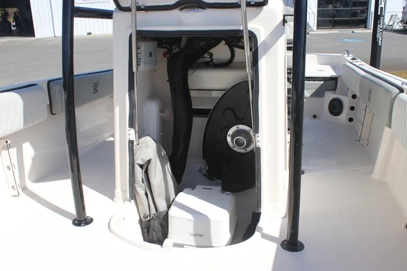 Slide: The Image of 2025 Carolina Skiff 21 Ultra Elite boat interior with storage compartment and equipment. - 7