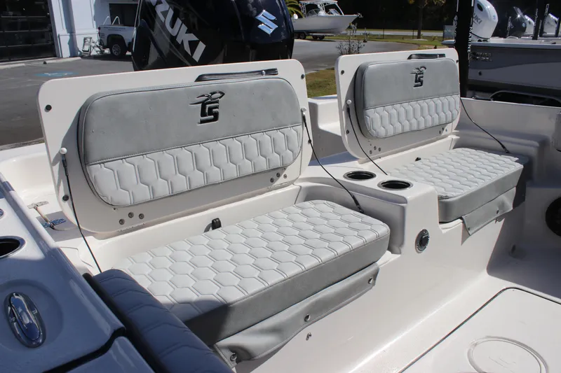 Slide: The Image of 2025 Carolina Skiff 21 Ultra Elite boat seats with gray upholstery and cup holders. - 8
