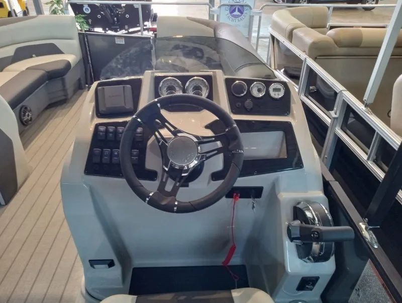 Slide: The Image of 2023 SunChaser Geneva Sport 25 SB boat dashboard with steering wheel and control panel. - 3