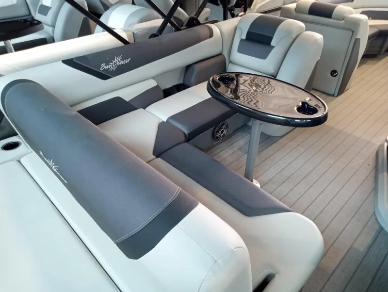 Slide: The Image of 2023 SunChaser Geneva Sport 25 SB interior with plush seating and a sleek table. - 6