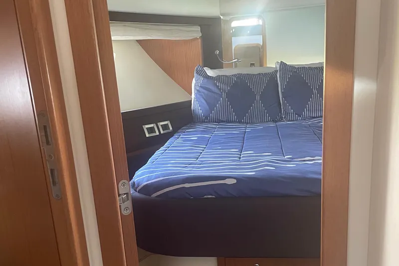 Slide: The Image of Luxurious bedroom interior of 2012 Ferretti Yachts 530 with blue bedding. - 10