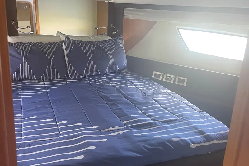 Slide: The Image of Luxurious bedroom interior of 2012 Ferretti Yachts 530 with blue bedding. - 11