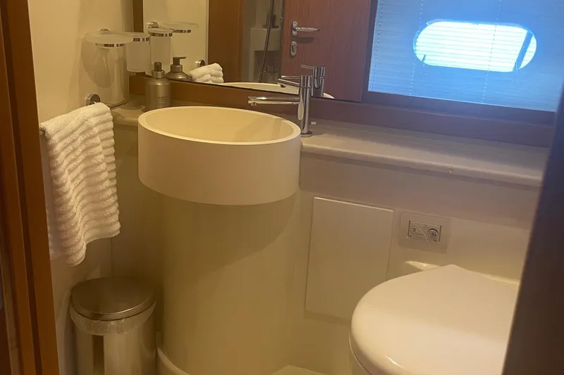 Slide: The Image of Luxurious bathroom in 2012 Ferretti Yachts 530, featuring modern sink and porthole window. - 13