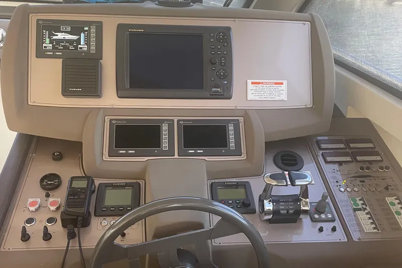 Slide: The Image of Control panel of a 2012 Ferretti Yachts 530, featuring navigation and communication equipment. - 14