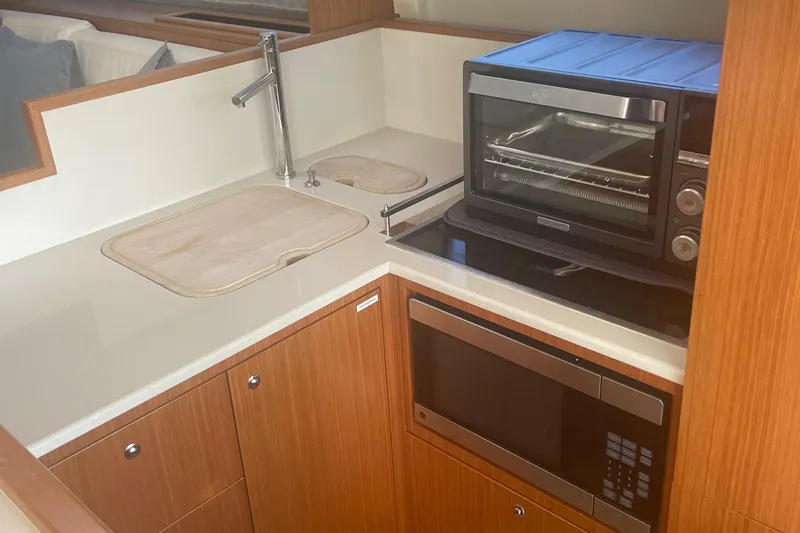 Slide: The Image of Compact kitchen area in a 2012 Ferretti Yachts 530, featuring modern appliances. - 7