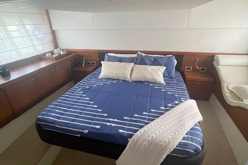 Slide: The Image of Luxurious bedroom interior of 2012 Ferretti Yachts 530 with modern bedding and wood accents. - 9