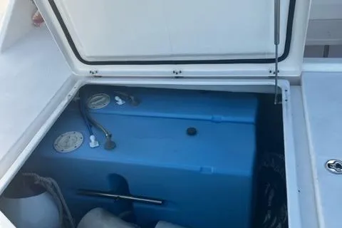 Slide: The Image of Open storage compartment on 2016 Leopard 48 yacht, featuring a blue water tank. - 11