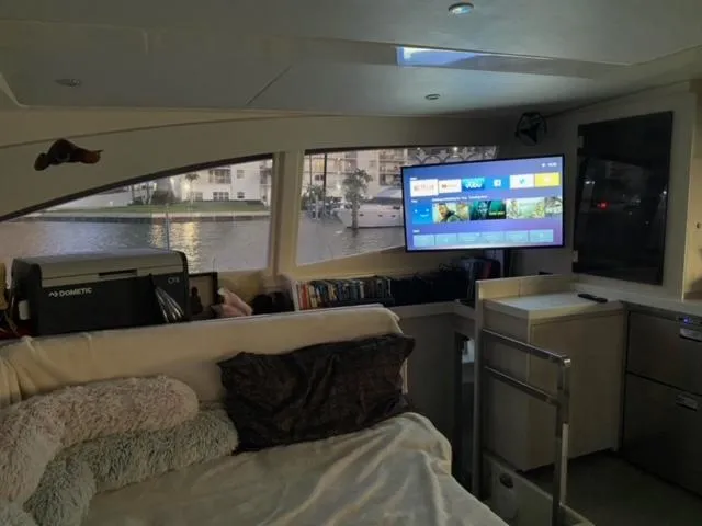 Slide: The Image of Interior of a 2016 Leopard 48 yacht with cozy seating and a mounted TV. - 16