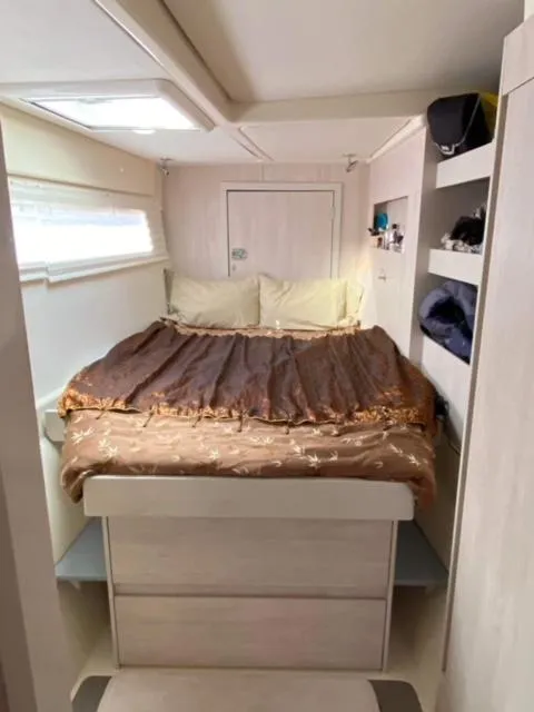 Slide: The Image of Cozy bedroom in 2016 Leopard 48 yacht with double bed and storage shelves. - 20