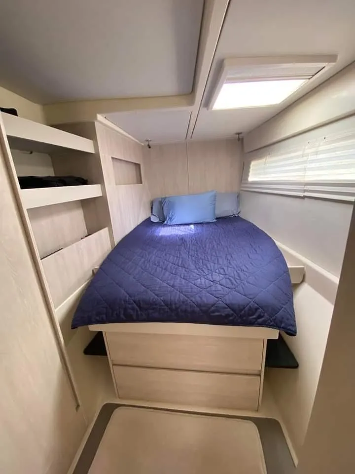 Slide: The Image of Cozy bedroom in 2016 Leopard 48 yacht with blue bedding and ample storage. - 21