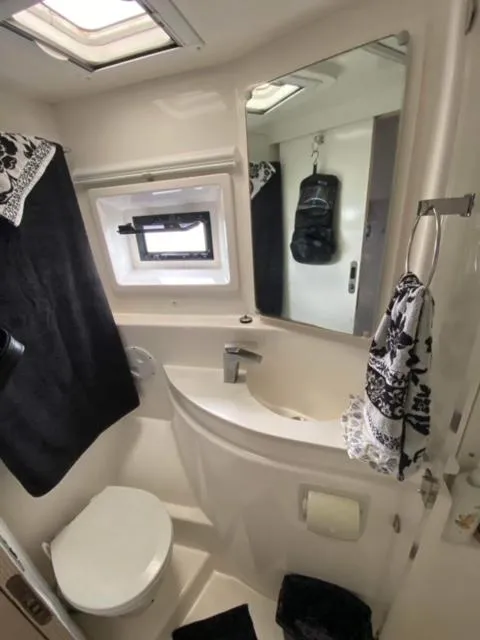 Slide: The Image of Compact bathroom in a 2016 Leopard 48 yacht with modern fixtures and nautical decor. - 26