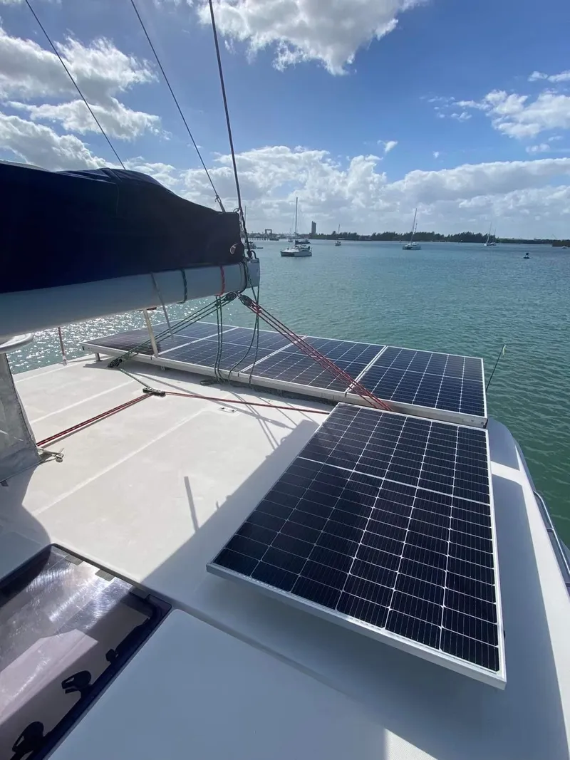 Slide: The Image of Leopard 48 catamaran with solar panels on deck, sailing in sunny waters. - 3