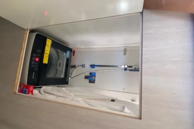 Slide: The Image of Compact laundry area with a washing machine inside a Leopard 48 yacht, 2016 model. - 33