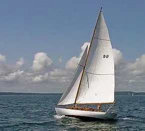 Slide: The Image of 1929 Herreshoff Fishers Island 31 sailboat on open water under clear skies. - 11