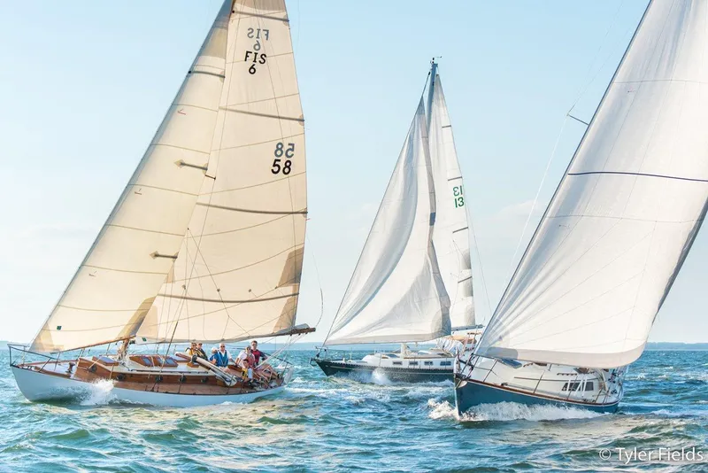 Slide: The Image of Sailboats racing on the ocean, featuring a 1929 Herreshoff Fishers Island 31. - 13