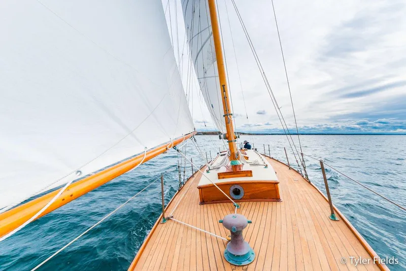 Slide: The Image of Sailing on a 1929 Herreshoff Fishers Island 31 yacht with wooden deck and white sails. - 15