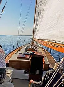 Slide: The Image of 1929 Herreshoff Fishers Island 31 sailboat on calm waters, viewed from the deck. - 19