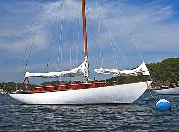 Slide: The Image of 1929 Herreshoff Fishers Island 31 sailboat on calm water, blue sky background. - 21