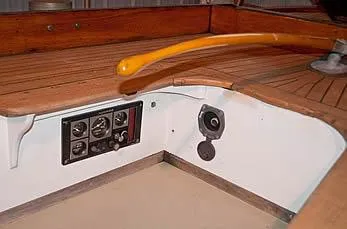 Slide: The Image of 1929 Herreshoff Fishers Island 31 cockpit with wooden tiller and instrument panel. - 26