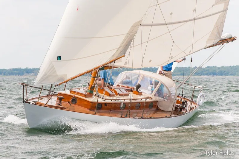 Slide: The Image of 1929 Herreshoff Fishers Island 31 sailing on open water, showcasing classic wooden design. - 3