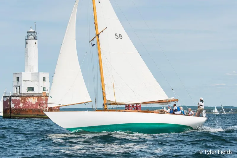 Slide: The Image of 1929 Herreshoff Fishers Island 31 sailboat near lighthouse on open water. - 8