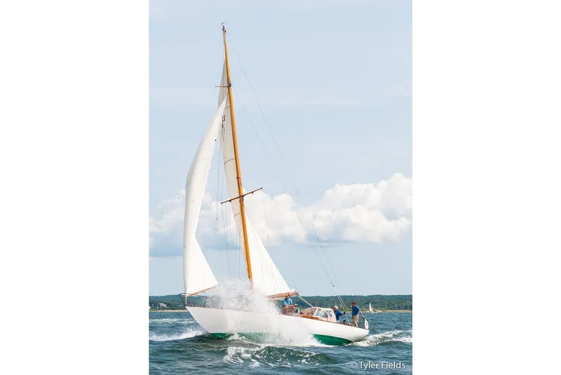 Slide: The Image of 1929 Herreshoff Fishers Island 31 sailboat navigating through waves on a sunny day. - 9