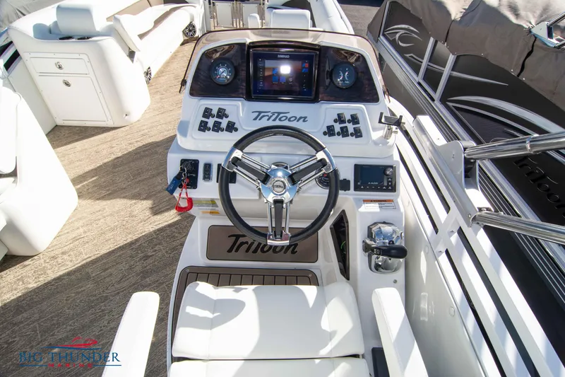 Slide: The Image of 2022 JC NEPTOON 27 TT SPORT boat cockpit with steering wheel and control panel. - 23