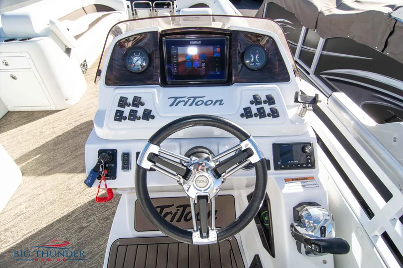 Slide: The Image of Control panel of a 2022 JC NEPTOON 27 TT SPORT boat with steering wheel and dashboard. - 24