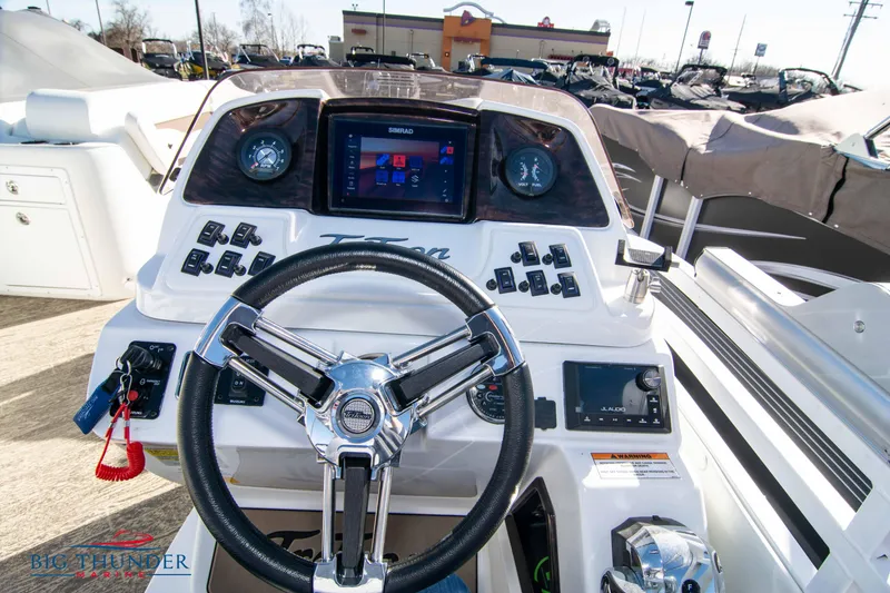 Slide: The Image of Control panel of 2022 JC NEPTOON 27 TT SPORT boat with steering wheel and navigation system. - 25