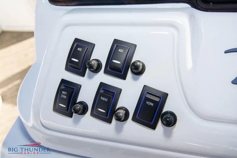 Slide: The Image of Control panel of a 2022 JC NEPTOON 27 TT SPORT boat with various switches. - 29